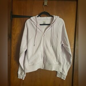 Zip up hoodie with pockets light pink in color